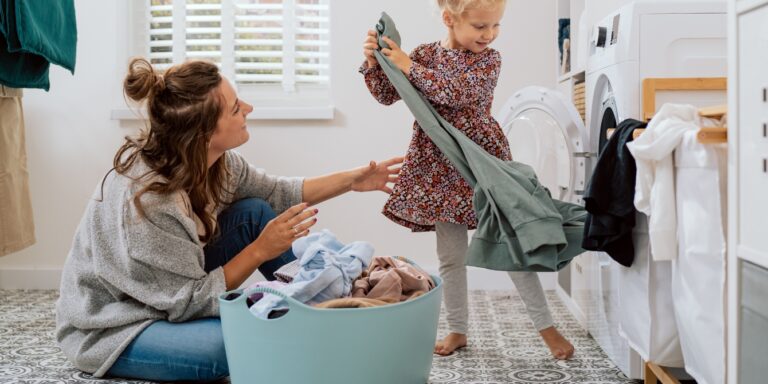 mom and daughter doing laundry