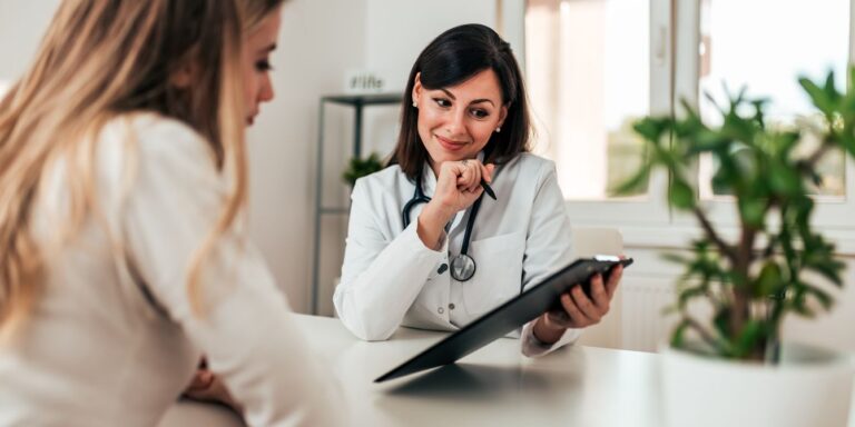 doctor talking to woman in doctors office