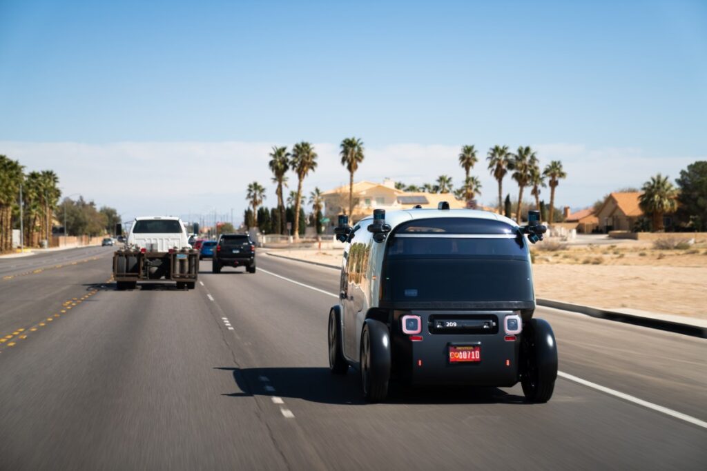 zoox robotaxi driving down a road in las vegas